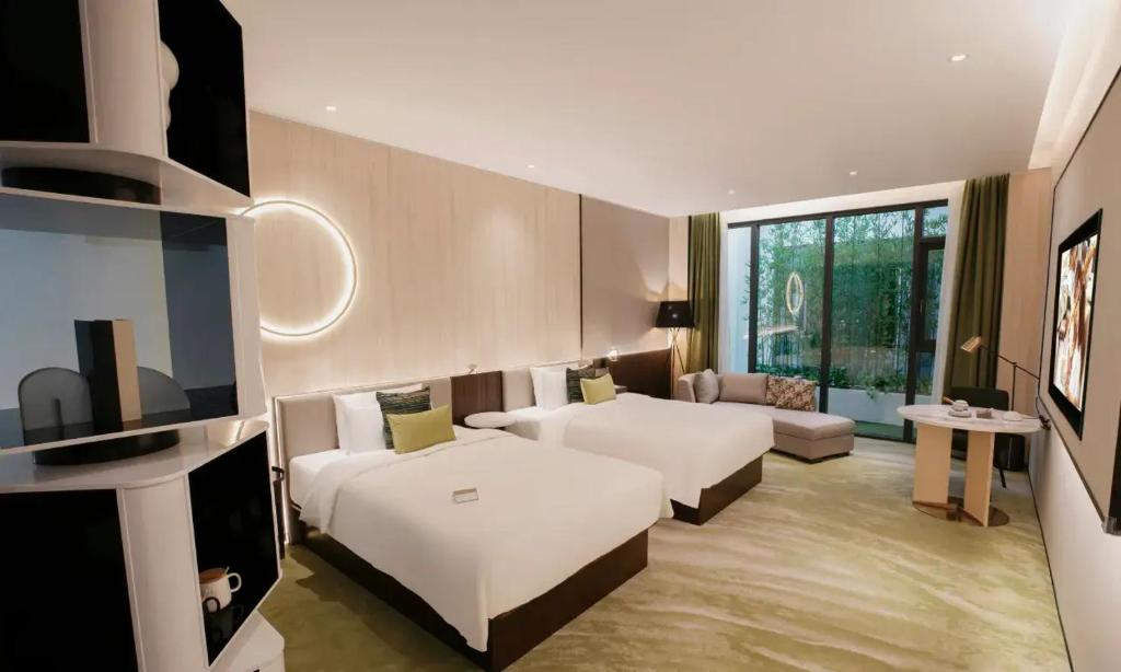 Ένα ή περισσότερα κρεβάτια σε δωμάτιο στο Wuhan Hazens Hotel
