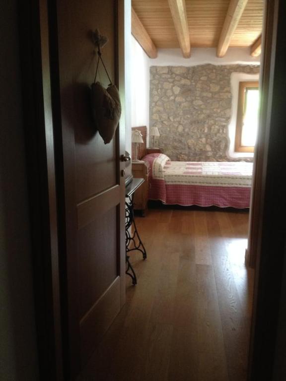 an open door to a bedroom with a bed at Il Capriolo Felice - Agriturismo in Lastebasse