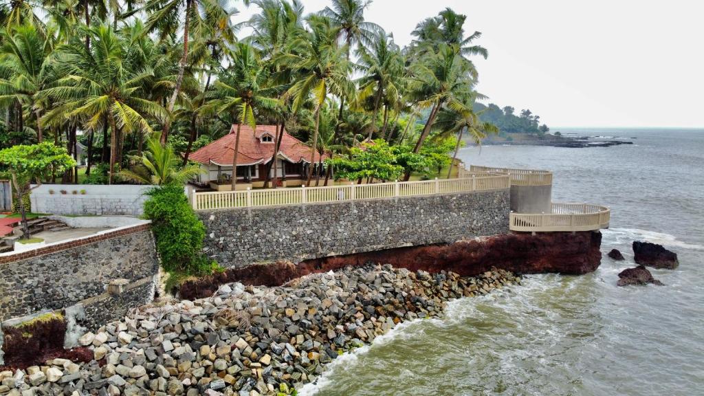 a house on the shore of the water at Willo stays beach cottage in Kannur