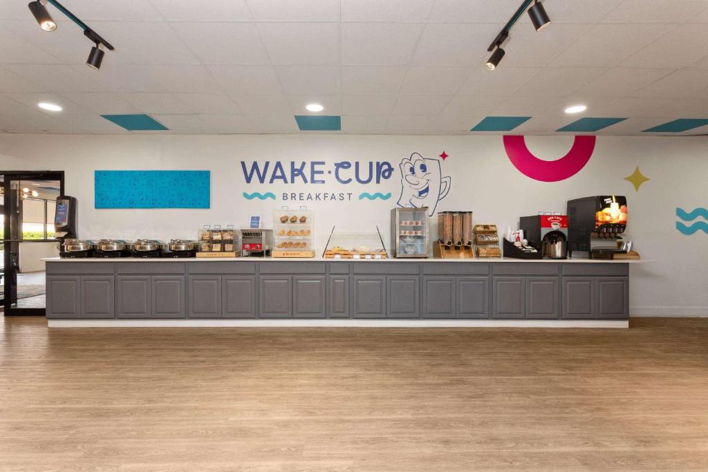 a food counter in a store with a sign on the wall at Baymont by Wyndham Orlando North Millenia in Orlando