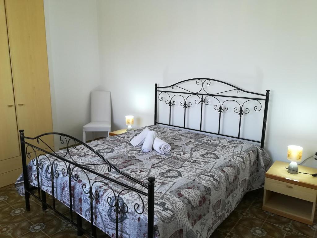 a bedroom with a bed with a stuffed animal on it at Villa Maddalena a Otranto in Otranto