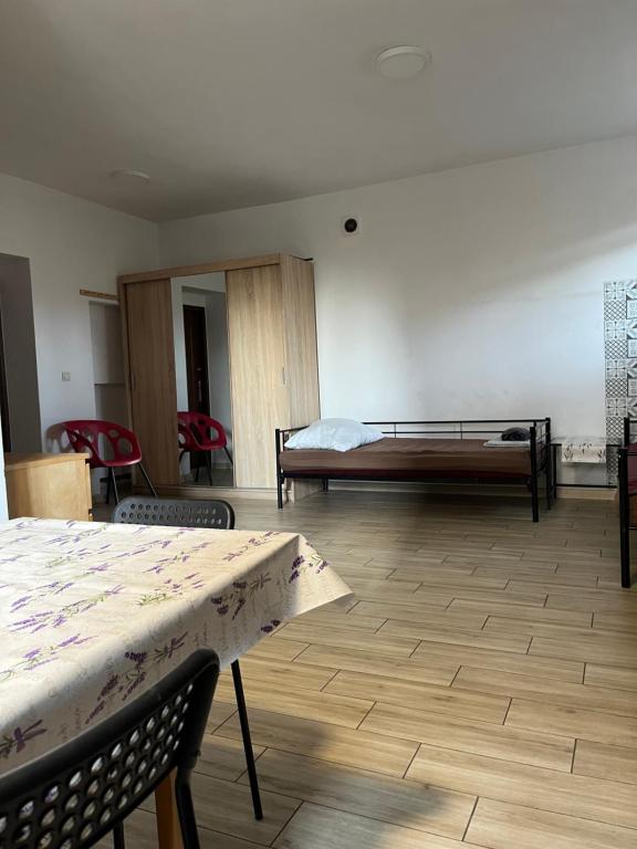 a room with a bed and a table and chairs at Apartament 02 in Poznań