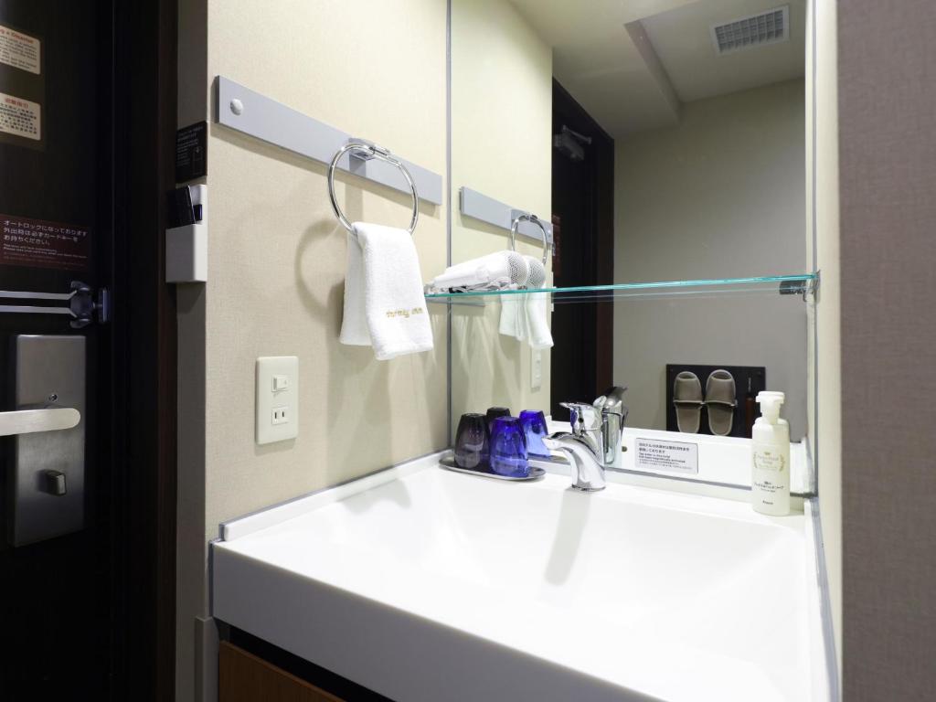 Koupelna v ubytování Tennen Onsen Taho-no-Yu Dormy Inn Niigata