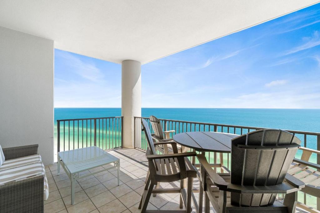 a balcony with a table and chairs and the ocean at The Oasis at Orange Beach 2206 (Phoenix West II) in Orange Beach