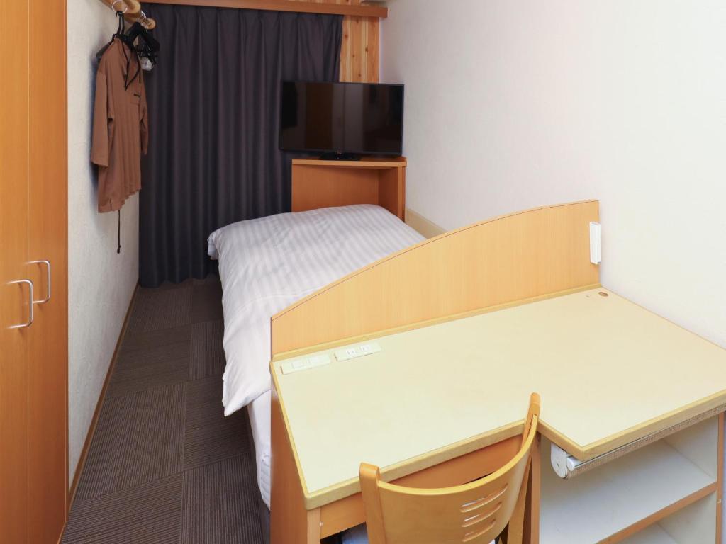 Postel nebo postele na pokoji v ubytování Tennen Onsen Taho-no-Yu Dormy Inn Niigata