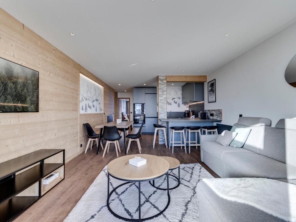 a living room with a couch and a table at Appartement 8 pers, skis aux pieds, balcon, rénové, proche pistes et commerces, Tignes le Lac - FR-1-641-32 in Tignes