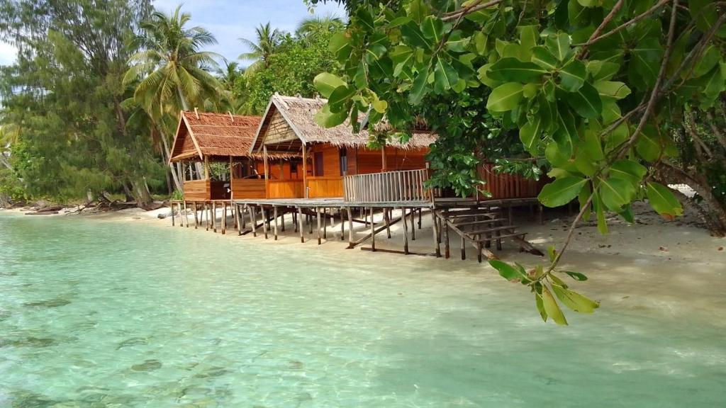 a house on the shore of a island in the water at Marlina Homestay in Fam