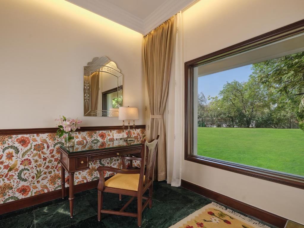 a home office with a desk and a window at The Ummed Ahmedabad Airport in Ahmedabad