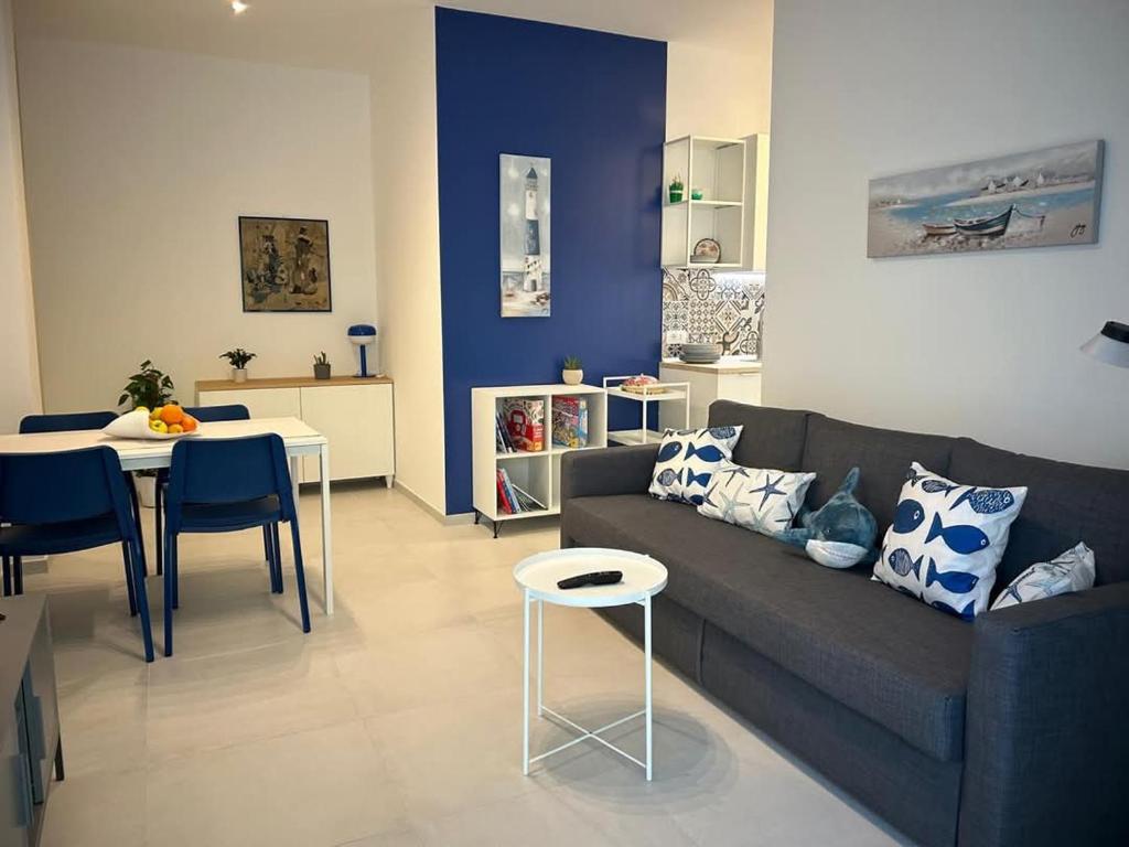 a living room with a couch and a table at Casa al mare Teresa in Porto SantʼElpidio