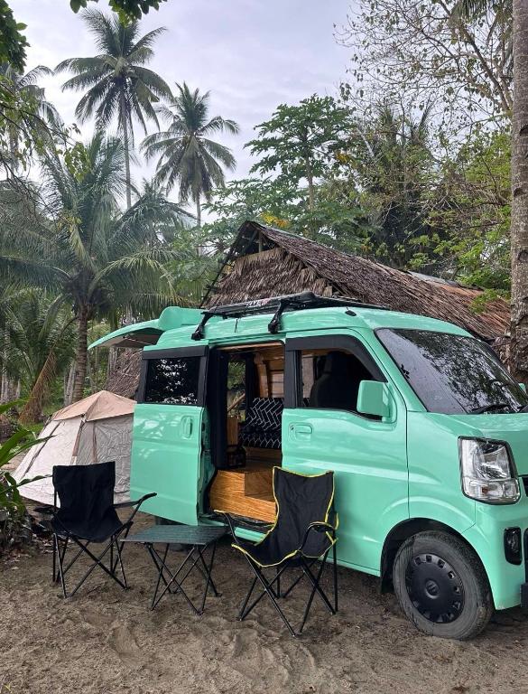 a green van with two chairs and a tent at Camper Van for Rent-Mini , El Nido in El Nido