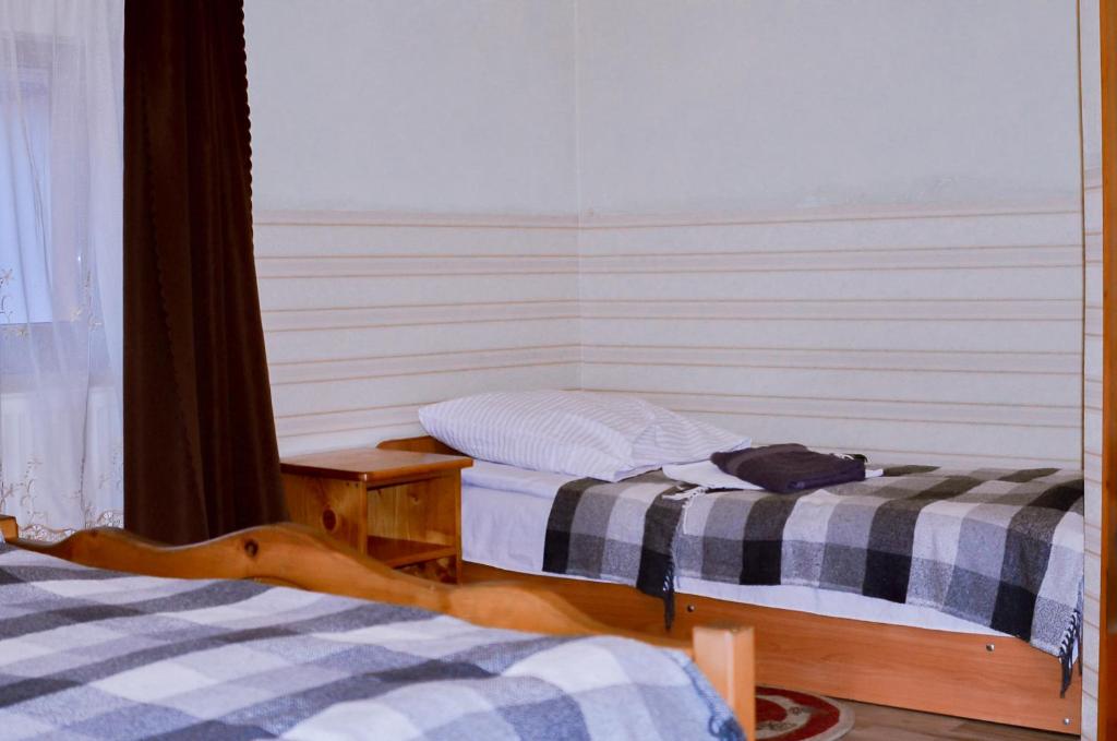 Postel nebo postele na pokoji v ubytování Guest House Mandrivnyi Rooms&Apartments