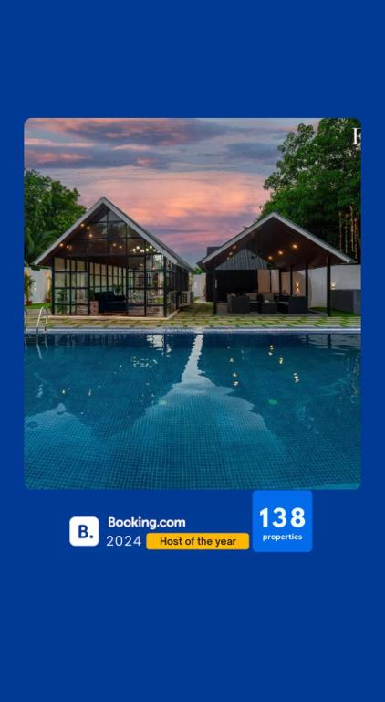 a picture of a house with a swimming pool at EKOSTAY - Oakwood Chalet in Alibaug