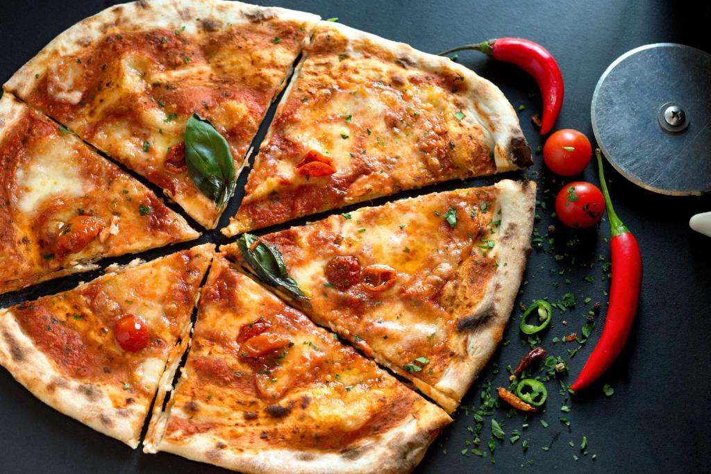 a pizza sitting on top of a table at Hampton by Hilton London Waterloo in London