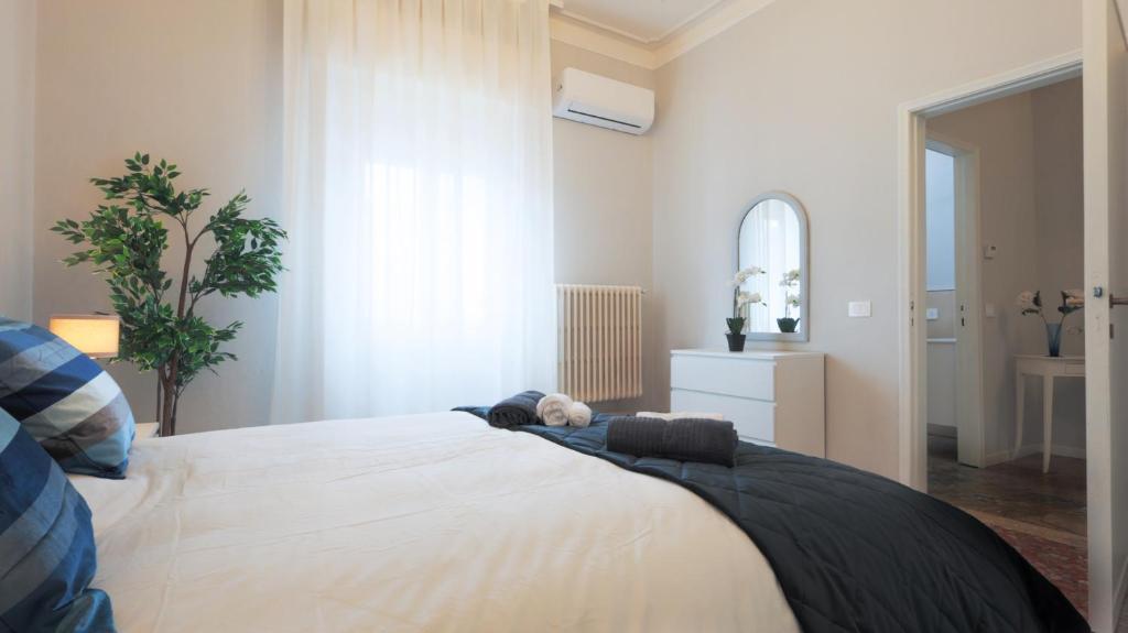 a bedroom with a bed with a teddy bear on it at Gabry family apartment in Prato