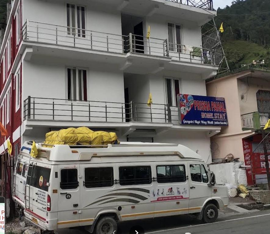 a white van parked in front of a building at Hotel prisha pahal Home stay in Uttarkāshi