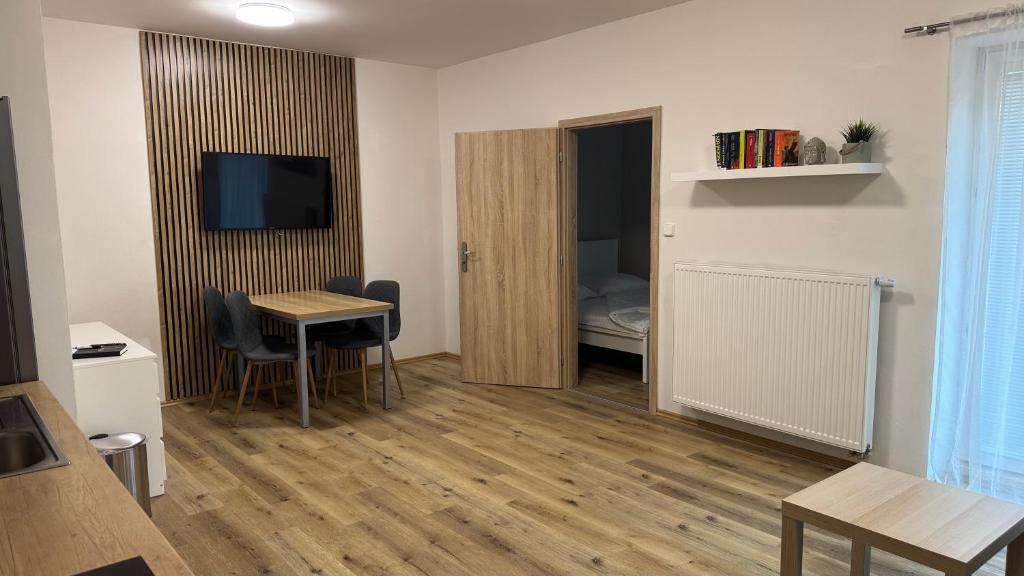 a room with a small table and a room with a bed at Apartment Urban Oasis in Olomouc
