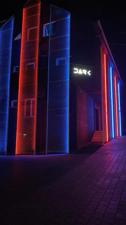 a building with red and blue lights on it at Dark Boutique Hotel in Tirana