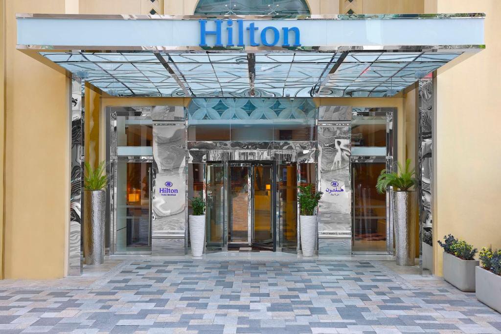 an entrance to a hotel with the doors open at Hilton Dubai The Walk in Dubai