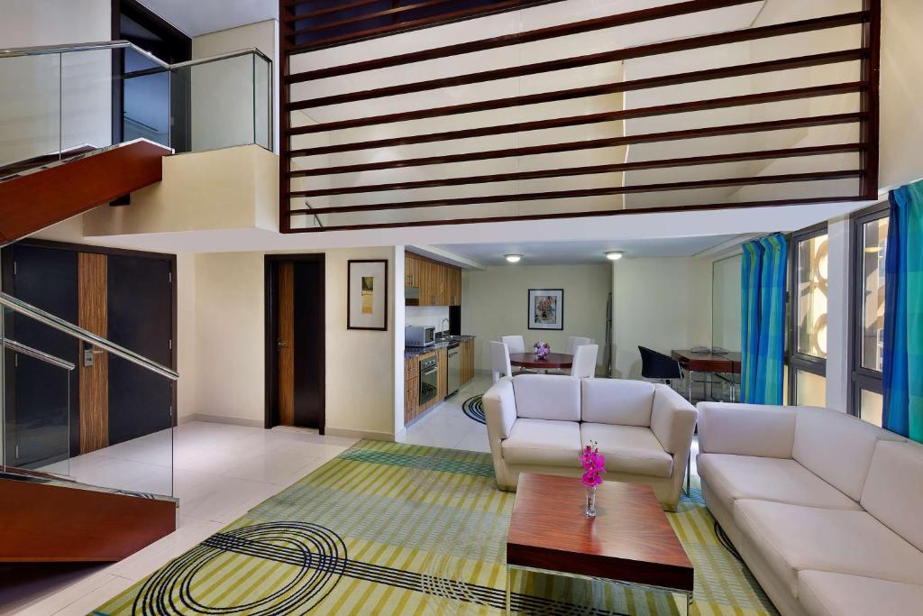 a living room with a couch and a table at Hilton Dubai The Walk in Dubai