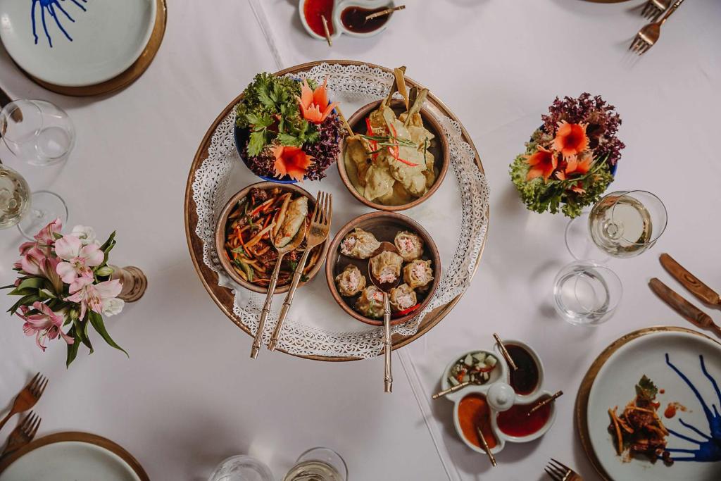 a white table with plates of food on it at Hilton Malta in St Julian's