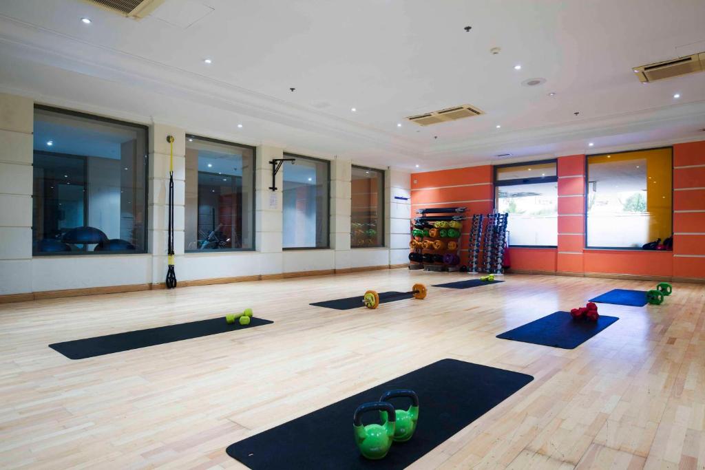 a room with a yoga class with mats on the floor at Hilton Malta in St Julian's