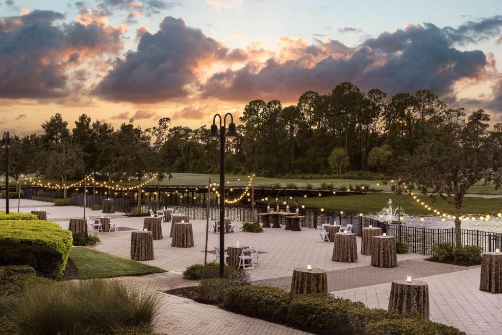 a patio with tables and lights in a park at Waldorf Astoria Orlando - An Official Walt Disney World Hotel in Orlando