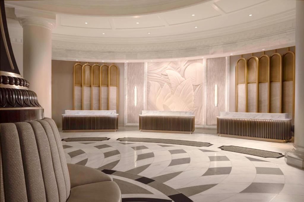 a hotel lobby with a waiting area with two at Waldorf Astoria Orlando - An Official Walt Disney World Hotel in Orlando