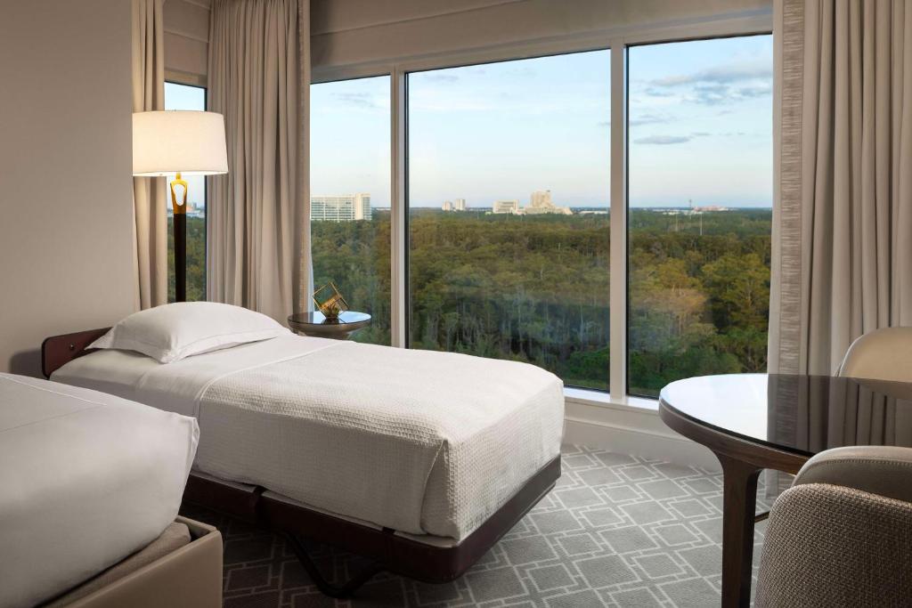 a hotel room with a bed and a large window at Waldorf Astoria Orlando - An Official Walt Disney World Hotel in Orlando