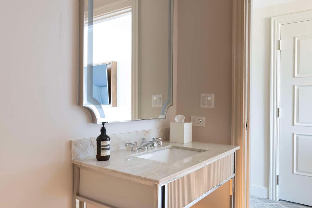 a bathroom with a sink and a mirror at Waldorf Astoria Orlando - An Official Walt Disney World Hotel in Orlando