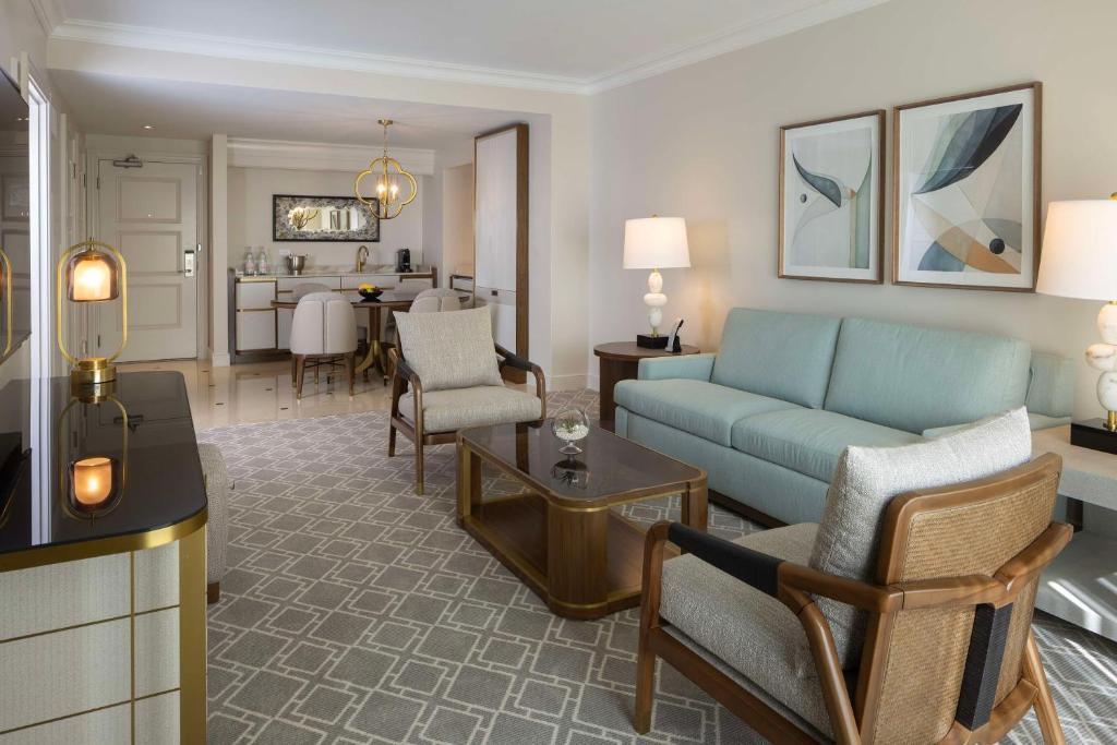 a living room with a couch and a dining room at Waldorf Astoria Orlando - An Official Walt Disney World Hotel in Orlando