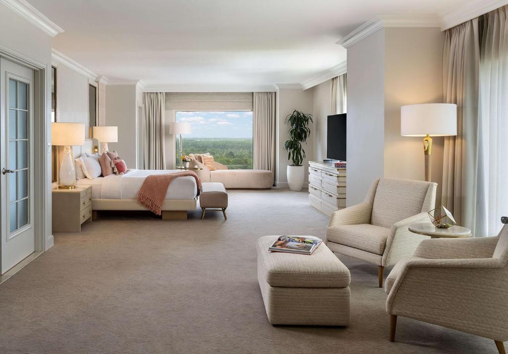 a large bedroom with a bed and a living room at Waldorf Astoria Orlando - An Official Walt Disney World Hotel in Orlando