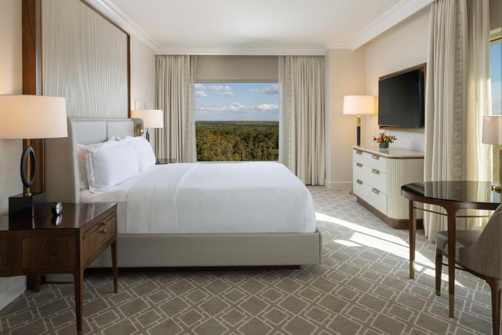 a hotel room with a bed and a large window at Waldorf Astoria Orlando - An Official Walt Disney World Hotel in Orlando