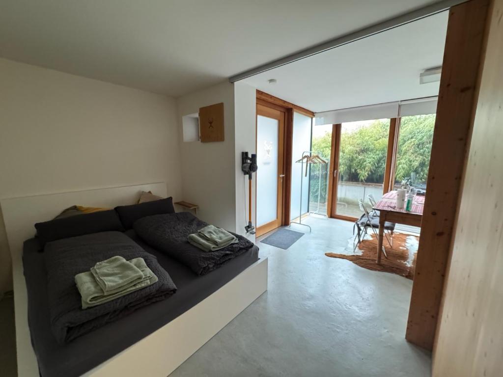 a bedroom with a bed and a large window at Gästewohnung zum Atelier in Immenstadt im Allgäu