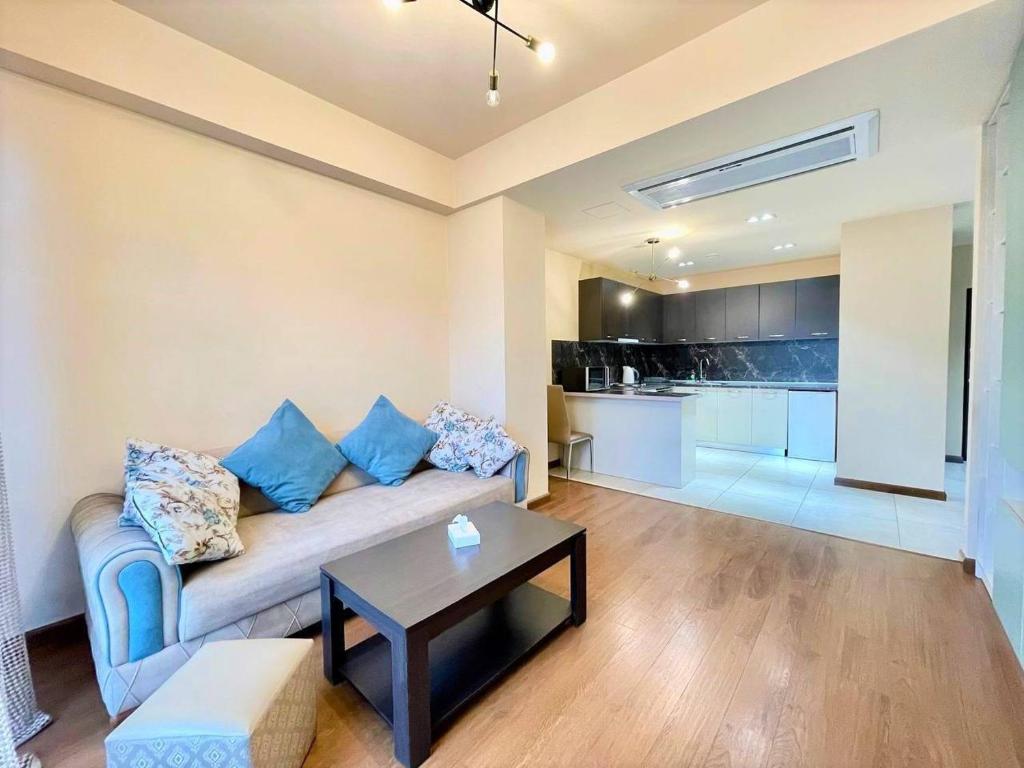 a living room with a couch and a table at Prime apartment in Buzand 17 with beautiful terrace in Yerevan