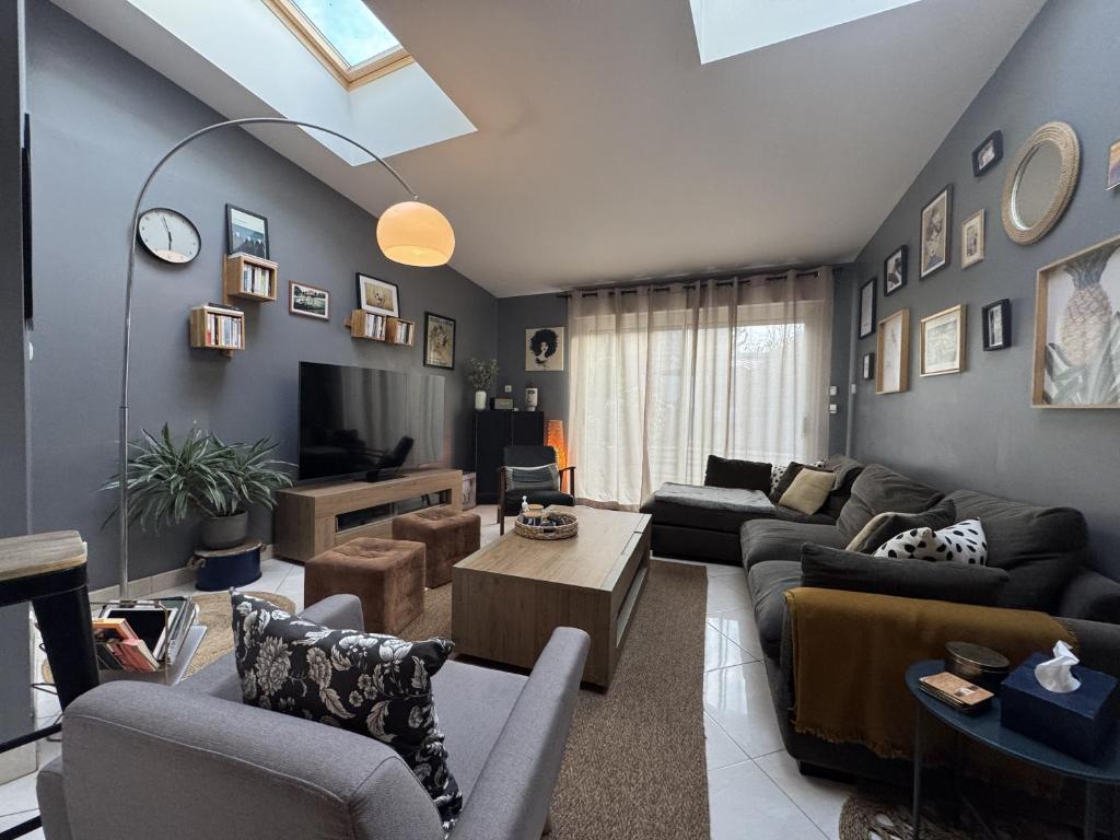 a living room with couches and a tv at The Light Downtown - 9 pers - 24h du Mans - Rêve au Mans in Le Mans