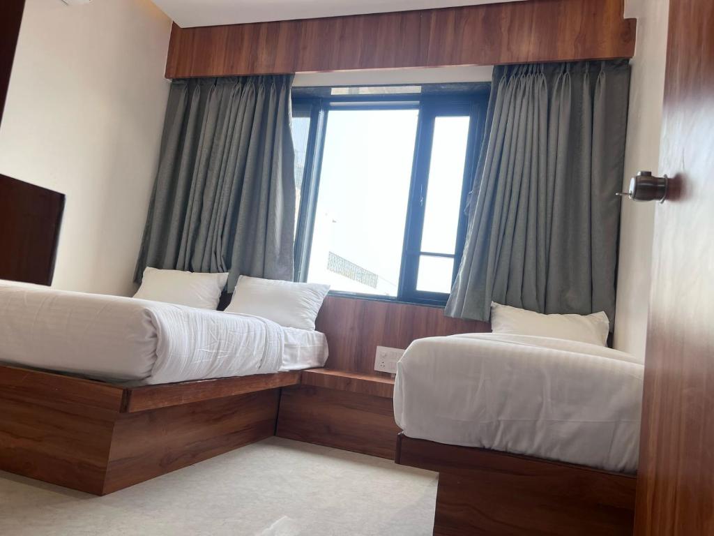 Postel nebo postele na pokoji v ubytování Hotel Rudraksh