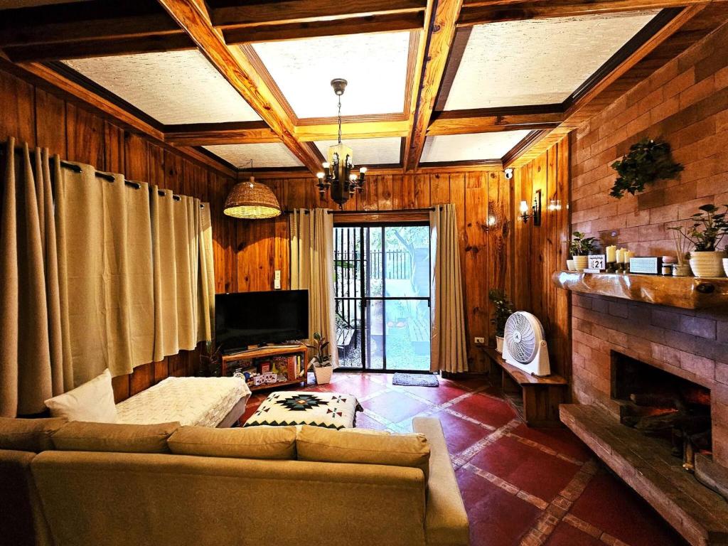 a living room with a couch and a fireplace at Guest Room 2A Transient Baguio Wifi Parking in Baguio