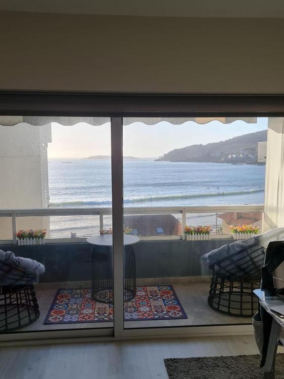 a view of the ocean from a room with a window at Panxon Madorra Mar in Panjón