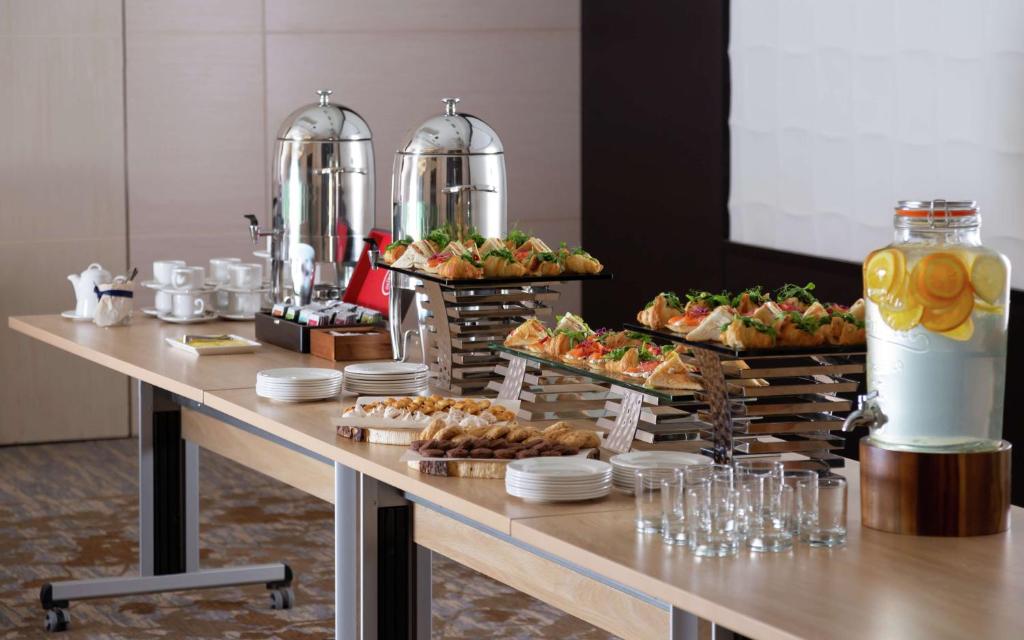 a buffet with appetizers and desserts on a table at DoubleTree By Hilton Moscow - Vnukovo Airport Hotel in Vnukovo
