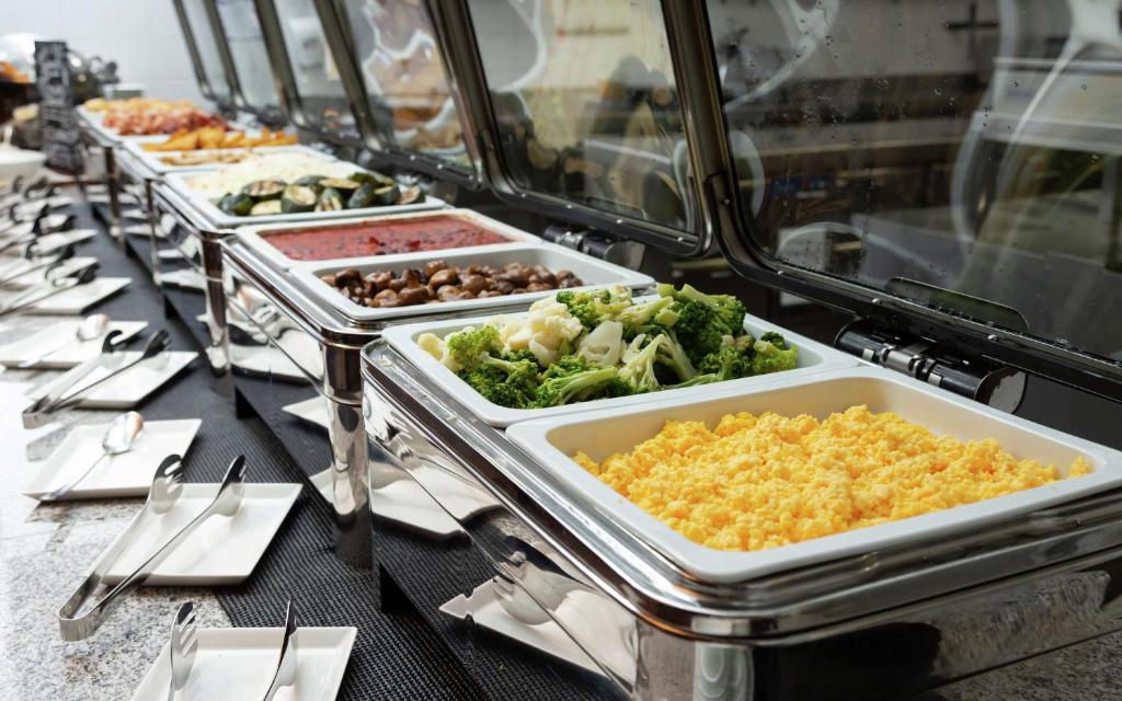 a buffet line with many different dishes of food at DoubleTree By Hilton Moscow - Vnukovo Airport Hotel in Vnukovo