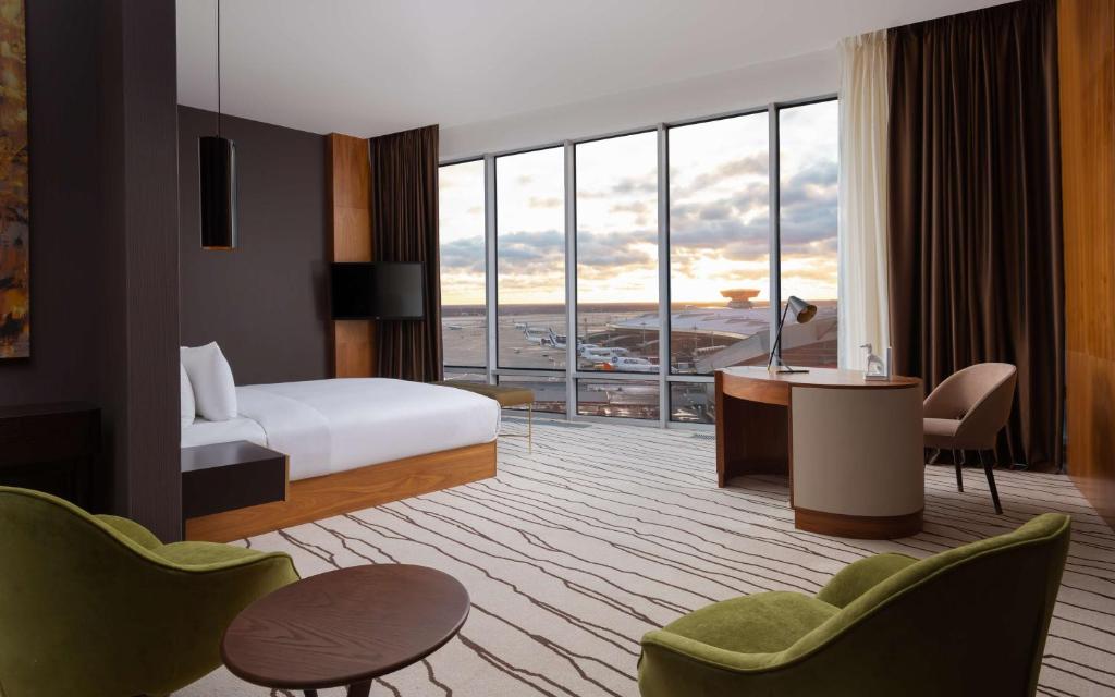 a hotel room with a bed and a desk at DoubleTree By Hilton Moscow - Vnukovo Airport Hotel in Vnukovo
