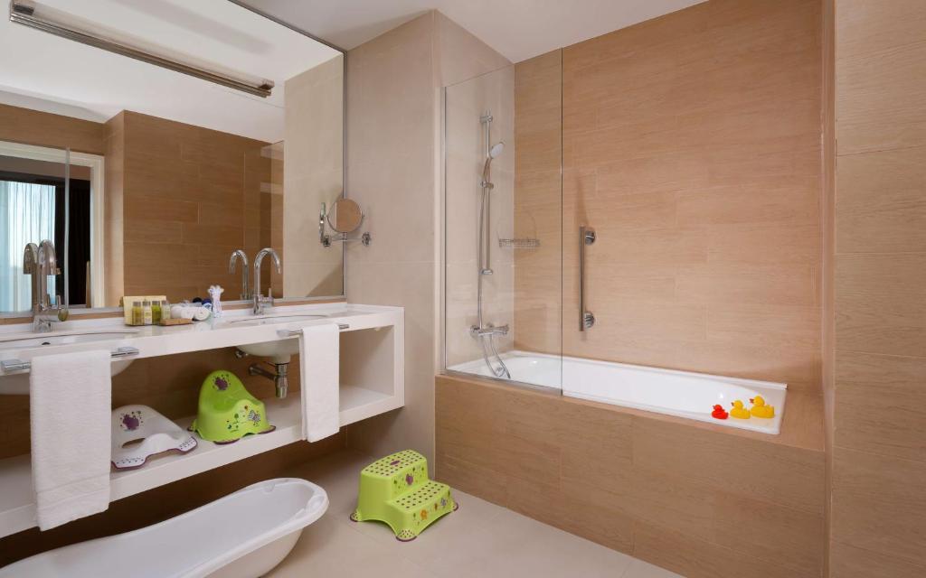 a bathroom with a tub and a toilet and a sink at DoubleTree By Hilton Moscow - Vnukovo Airport Hotel in Vnukovo