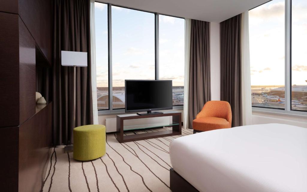 a hotel room with a bed and a flat screen tv at DoubleTree By Hilton Moscow - Vnukovo Airport Hotel in Vnukovo