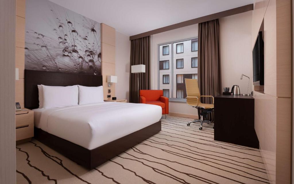 a hotel room with a white bed and a desk at DoubleTree By Hilton Moscow - Vnukovo Airport Hotel in Vnukovo