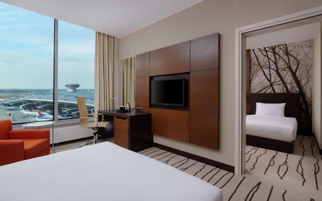 a hotel room with a bed and a television at DoubleTree By Hilton Moscow - Vnukovo Airport Hotel in Vnukovo