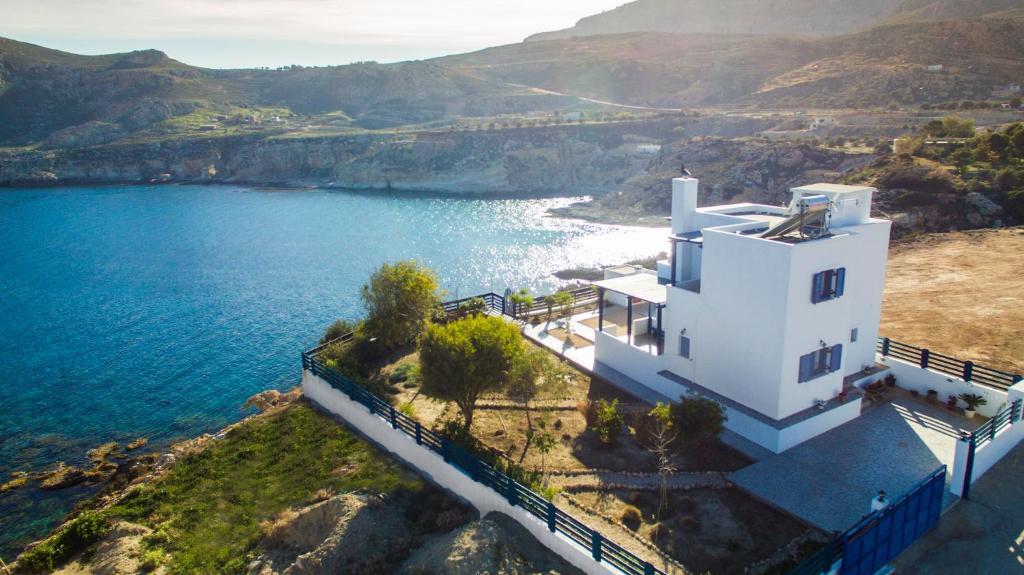 an aerial view of a white house by the water at Villa Elias in Archangelos