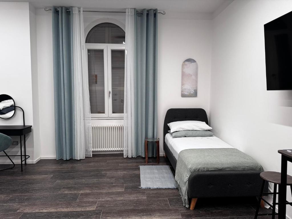 Postel nebo postele na pokoji v ubytování Appartamento Affittacamere'IL CONTE'