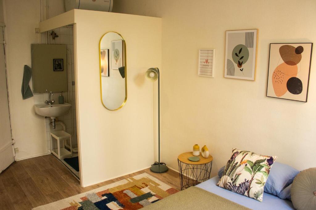 sala de estar con espejo y sofá en Saint Germain de Près tout équipé - Emplacement exceptionnel au Coeur de Paris, en París