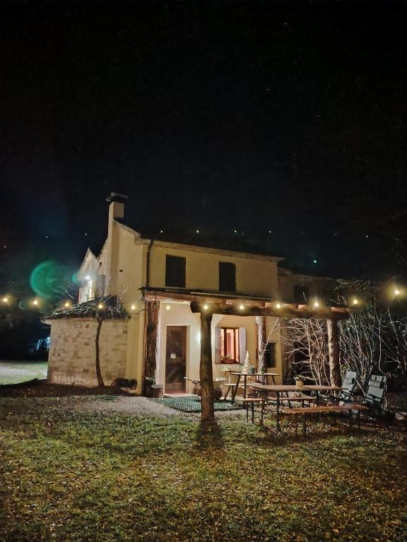 a house at night with a picnic table in front of it at La Caneveta al Piave in Valdobbiadene