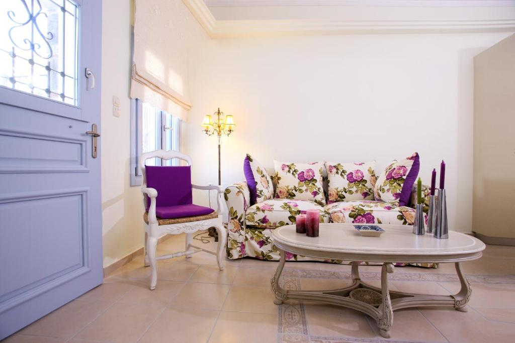 a living room with a couch and a table at Aegean Diamonds Boutique Villas in Loutraki